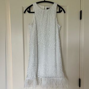 White sequin mini dress with feathers